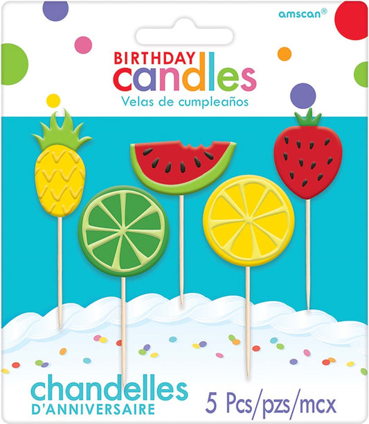 Set of five fruit-shaped birthday candles including pineapple, watermelon slice, strawberry, lime slice, and lemon slice on.