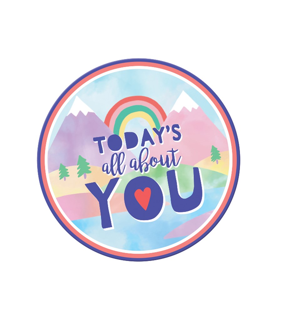 Round sticker with pastel mountains, rainbow, and text "Today's all about you" in colorful letters.