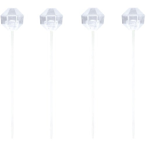 Set of four clear plastic picks with faceted diamond-shaped tops and thin pointed stems.