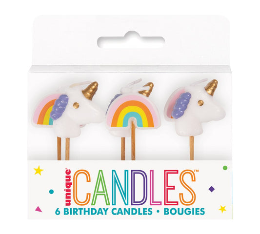 Set of six pink birthday candles featuring white unicorns with golden horns and rainbows.