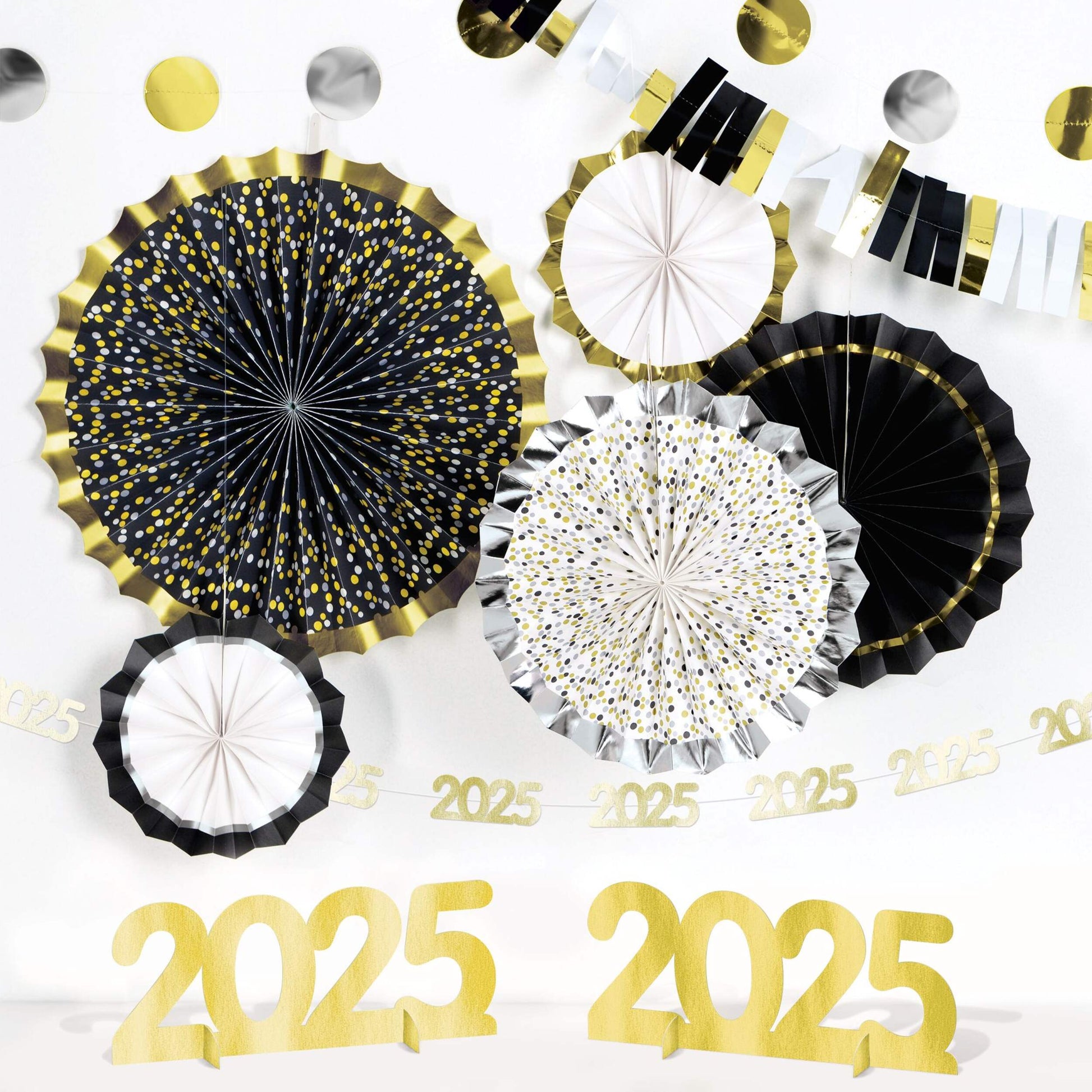 Black, silver, and gold paper fans with confetti and gold 2025 cutouts for New Year’s decoration.