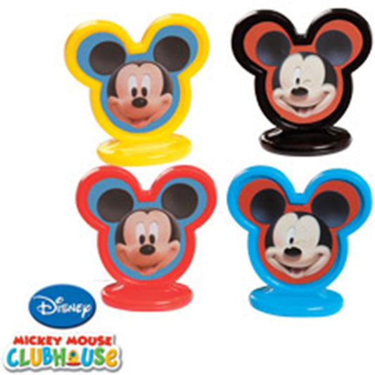 Four colorful Mickey Mouse head-shaped cake toppers in yellow, black, red, and blue bases with Mickey's smiling face in the.