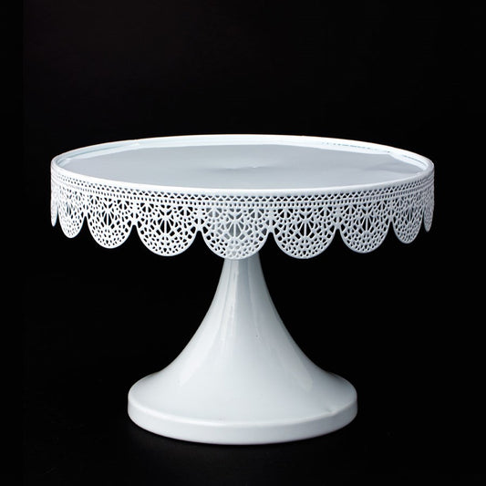 White metal pedestal cake stand with scalloped lace-like edge details, 6.75 inches wide.