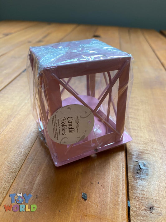 Pink metal candle cage with crossbar design and square base, wrapped in clear plastic.
