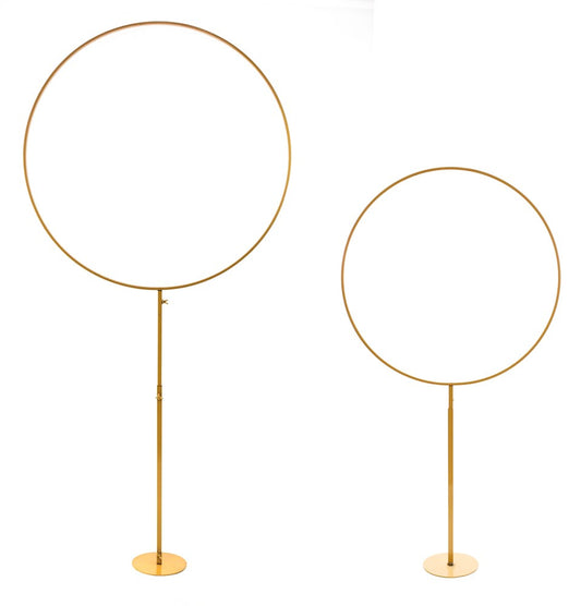 Set of two gold metal frames, one tall with circular shape on a thin stand, one shorter circular frame on a shorter stand.