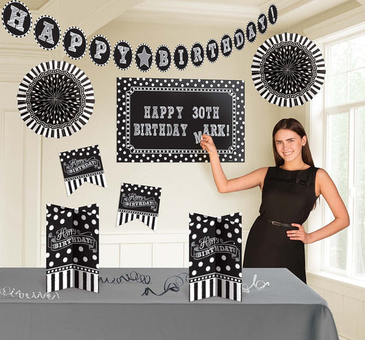 Black and white polka dot and stripe birthday decor kit with customizable banner and table covers.