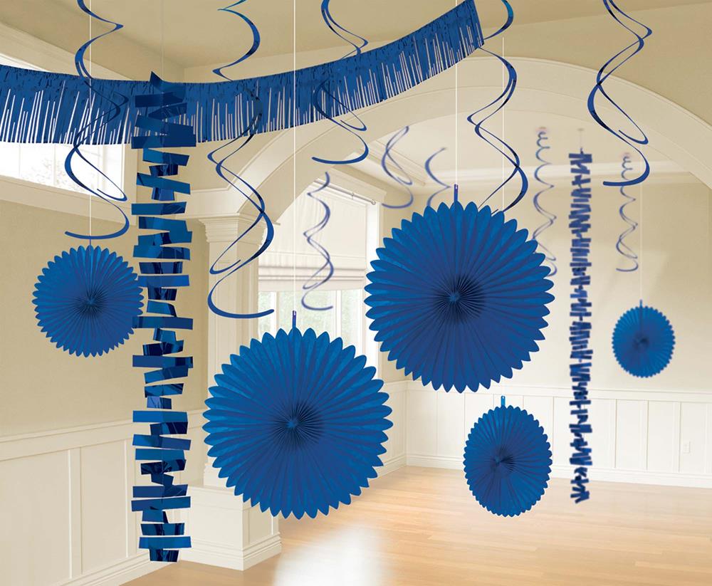 Bright royal blue hanging paper fans and swirl streamers party decorations in a room.
