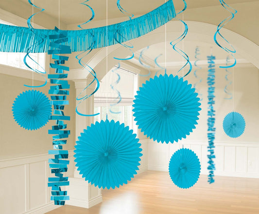Caribbean blue hanging paper fans, streamers, and fringed garland party decorations in a bright room.
