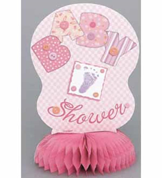 Pink honeycomb paper baby shower decoration with stitched letters spelling "BABY" and baby feet design.