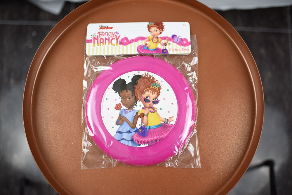 Pink plastic flying disc featuring Fancy Nancy and friend illustrations at center.