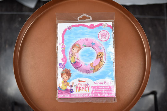 Pink inflatable swim ring featuring Fancy Nancy illustration and decorative swirls.