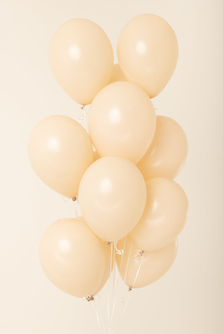 Cluster of cream-colored 11-inch latex balloons inflated with helium, glossy finish.