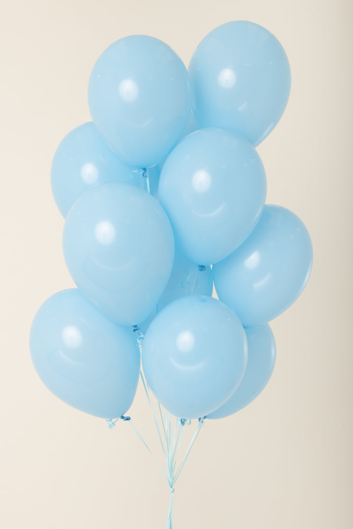 Cluster of light blue, 11-inch latex balloons inflated with helium and tied with white strings.