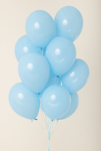 Cluster of light blue, 11-inch latex balloons inflated with helium and tied with white strings.