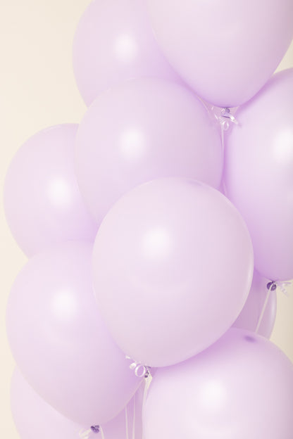 Glossy light purple latex balloons inflated and clustered together, 11 inches each.