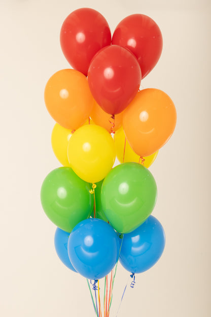 Cluster of 11-inch latex balloons in red, orange, yellow, green, and blue, helium inflated.