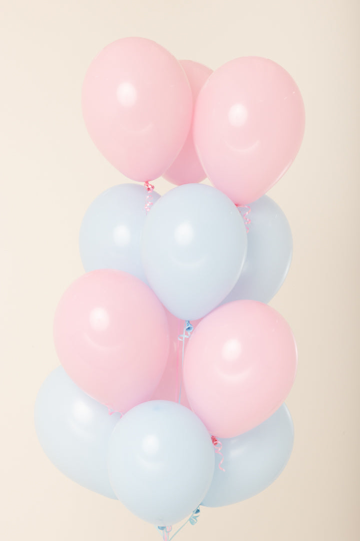Cluster of 11-inch pink and light blue helium latex balloons with a smooth, shiny surface.