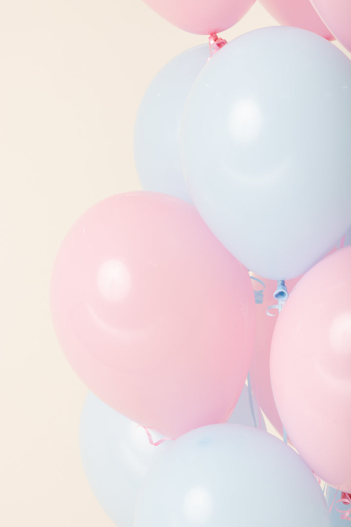 Cluster of helium-filled 11-inch latex balloons in soft pastel pink and light blue colors.