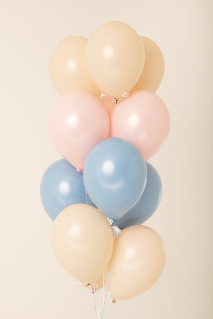 Cluster of 11-inch latex balloons in cream, pink, and blue, helium inflated and tied together.