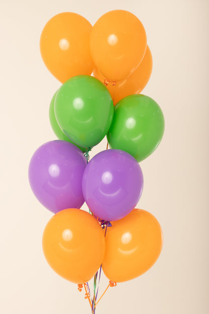 Cluster of 11-inch latex balloons in orange, green, and purple, inflated with helium.