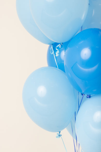 Cluster of helium-filled 11-inch latex balloons in varying shades of blue.