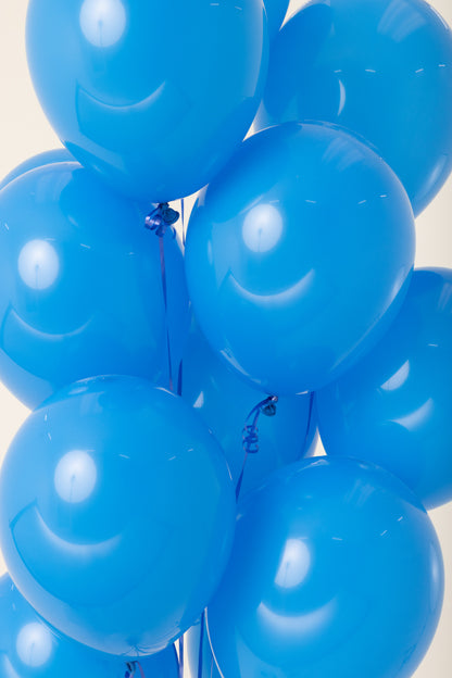 Cluster of shiny blue latex 11-inch helium-filled balloons tied together.
