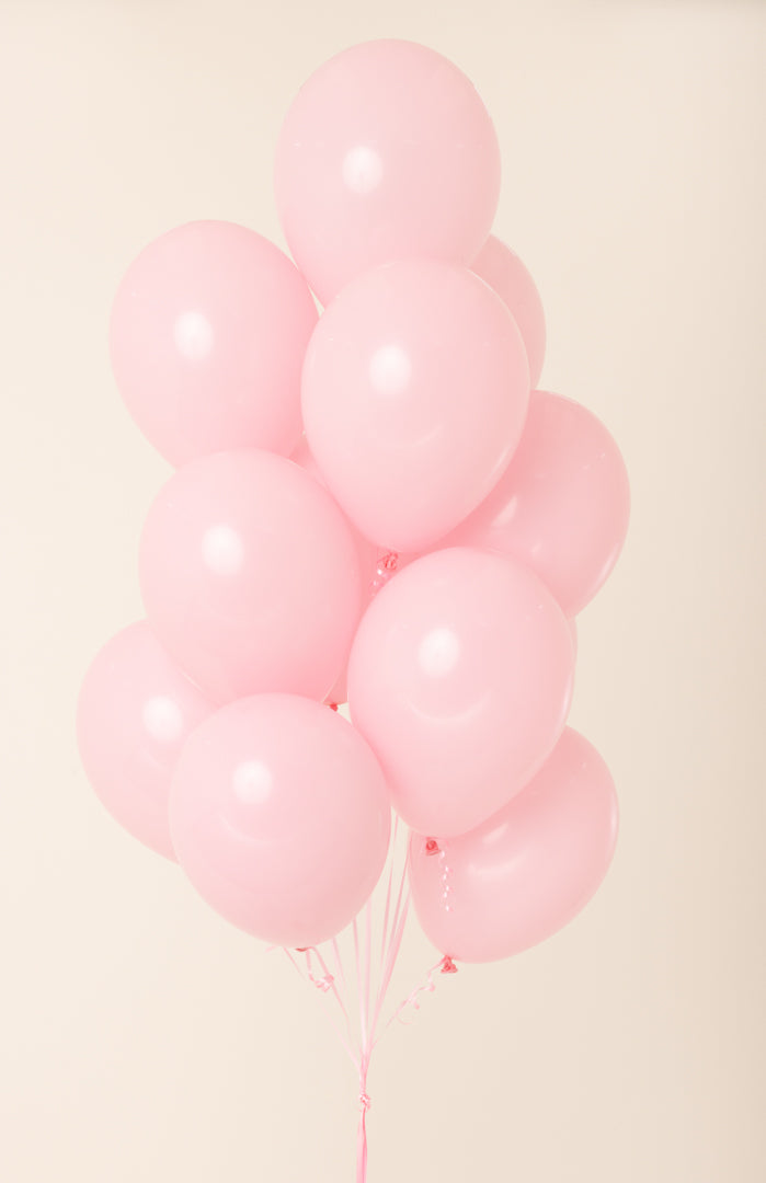 Cluster of glossy, pale pink latex balloons inflated with helium, each about 11 inches wide.