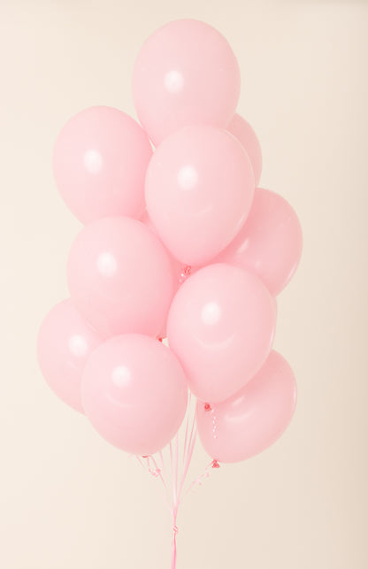 Cluster of glossy, pale pink latex balloons inflated with helium, each about 11 inches wide.