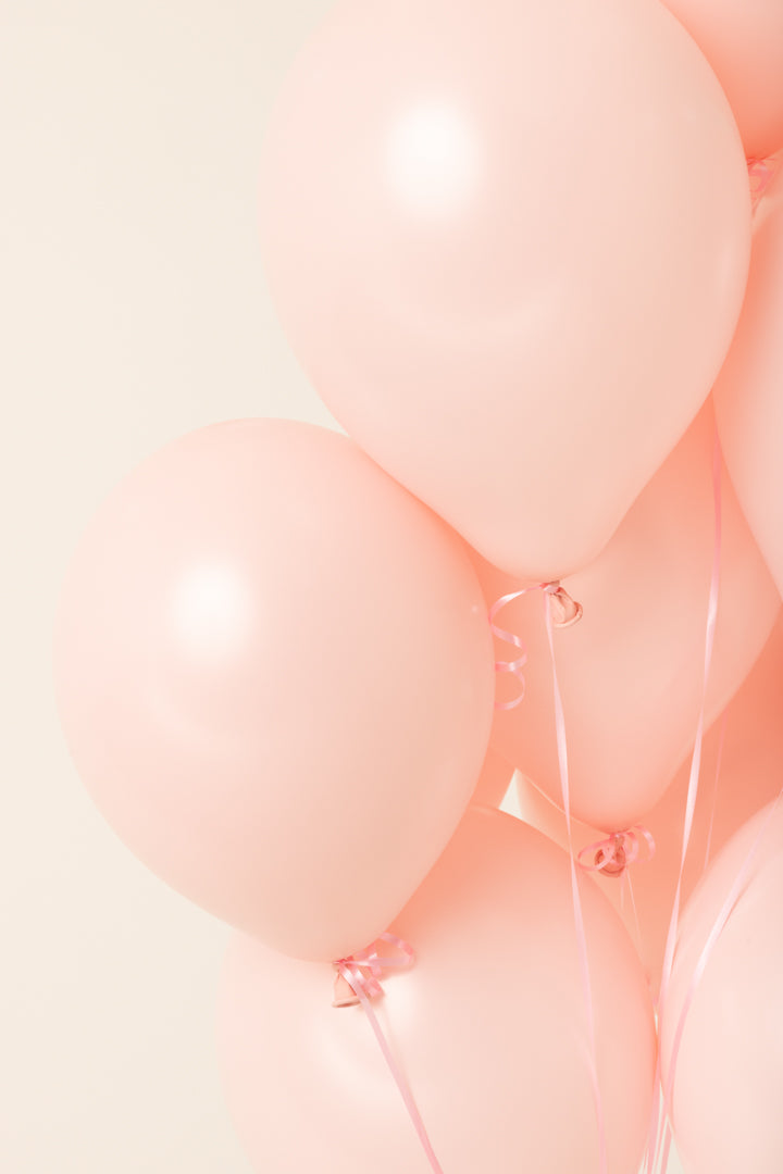 Soft pink 11 inch helium latex balloons with a smooth, glossy surface.