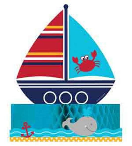 Colorful paper sailboat centerpiece with red, blue, and striped sails, a red crab, and a gray whale on a blue honeycomb base.