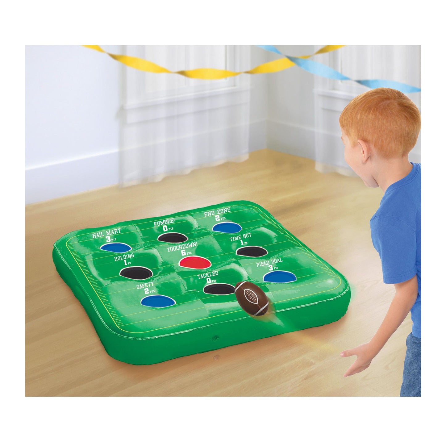 Green inflatable football toss game with colorful numbered target holes and a small brown football ball.