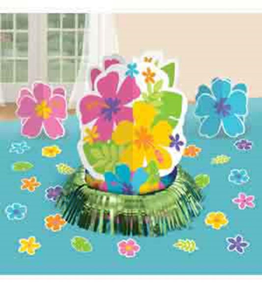Colorful hibiscus flower cutouts in pink, purple, yellow, and blue on a green grass-like base with scattered flower confetti