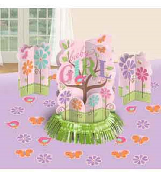 Pink and green baby girl table centerpiece with butterfly and flower accents on purple tablecloth.