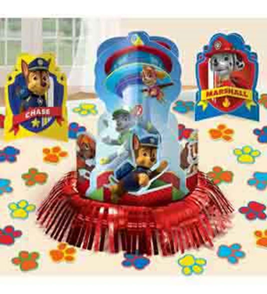 Paw Patrol table centerpiece with Chase, Marshall, and Skye on red fringe base surrounded by colorful paw prints.