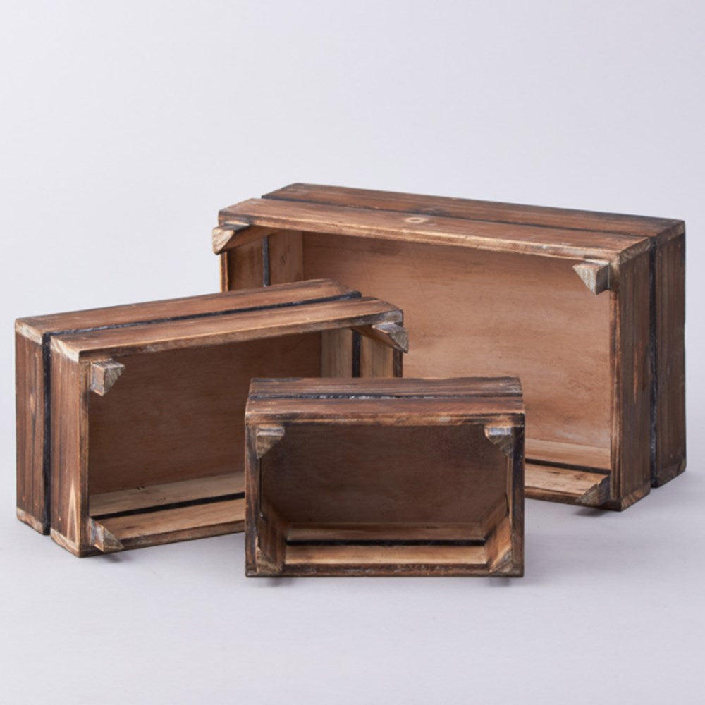 Set of three brown wooden crates with reinforced metal corner brackets, varying sizes.