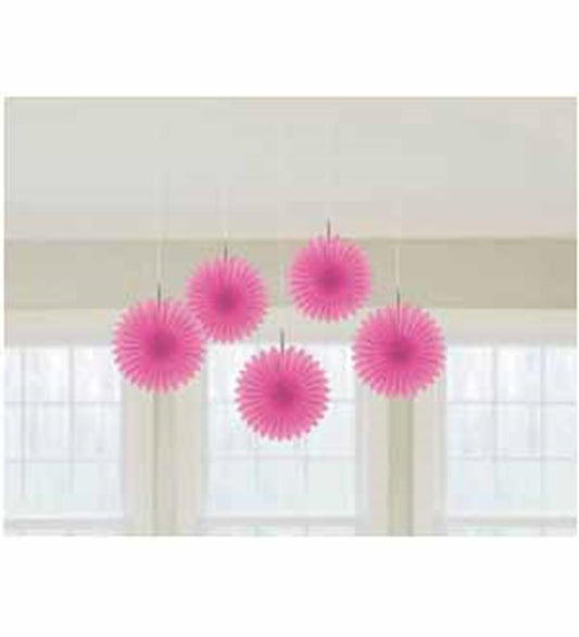 Five pink mini hanging paper fans with scalloped edges suspended indoors near windows.