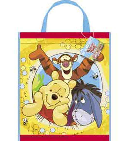 Yellow rectangular tote bag with blue handles featuring Winnie the Pooh, Tigger, and Eeyore cartoon characters.