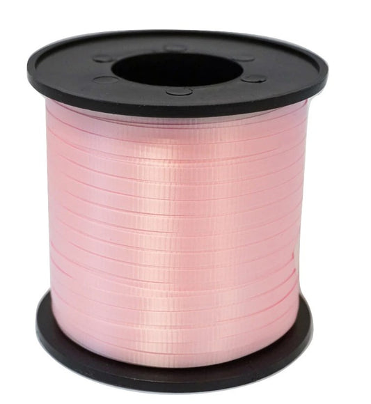 Spool of smooth, shiny baby pink ribbon wound tightly on black plastic reel.