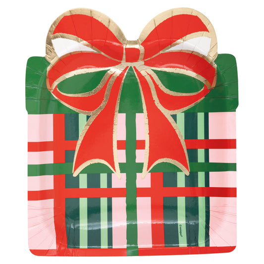 Square festive paper plate shaped like a gift with red and green plaid pattern and large red bow on top.