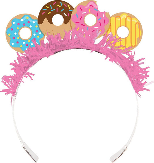 White plastic headband topped with four colorful donut-shaped decorations and pink fringe trim.