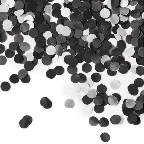 Scattered small round tissue paper confetti in black and white colors on a white background.