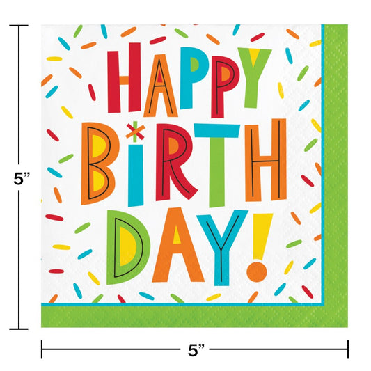 Colorful "Happy Birthday!" text with multicolored confetti and green border on white paper napkin.
