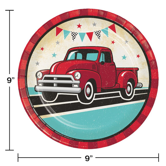 9-inch round paper plate with a vintage red truck illustration, plaid red border, and festive banner accents.