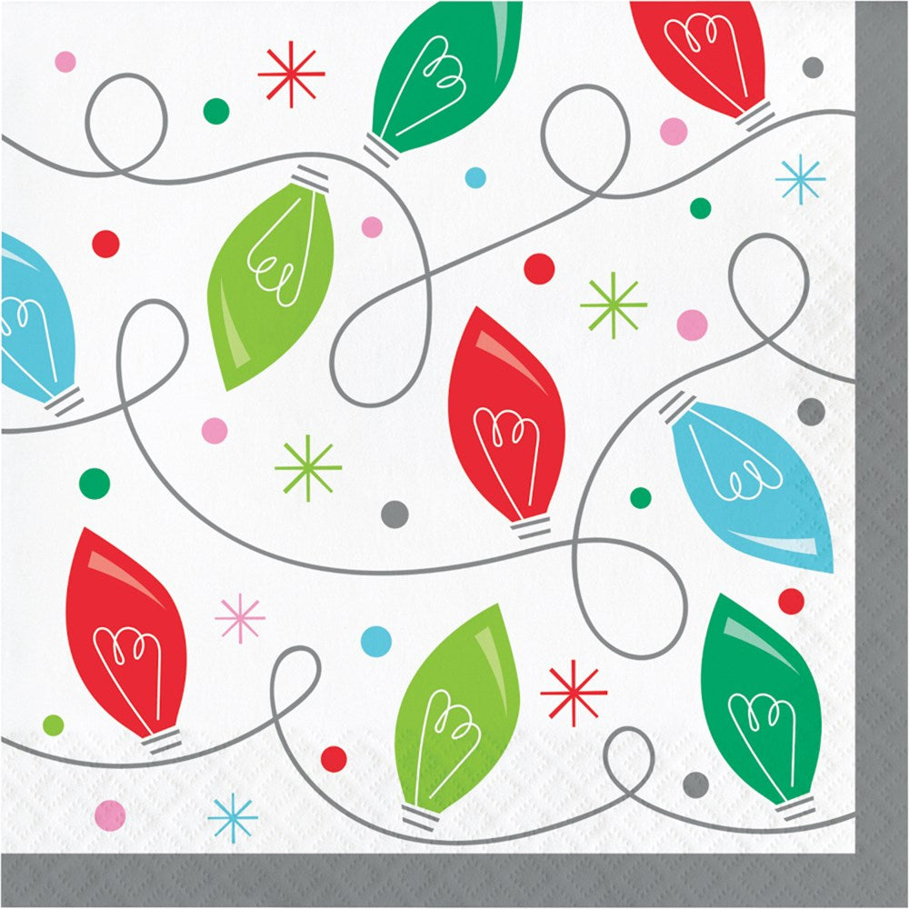 White square lunch napkin with colorful red, green, and blue holiday light bulbs and scattered starbursts and dots.