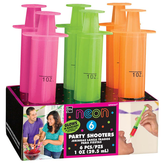 Set of six neon pink, green, and orange syringe shot glasses with 1 oz measurement marks in a black display box.