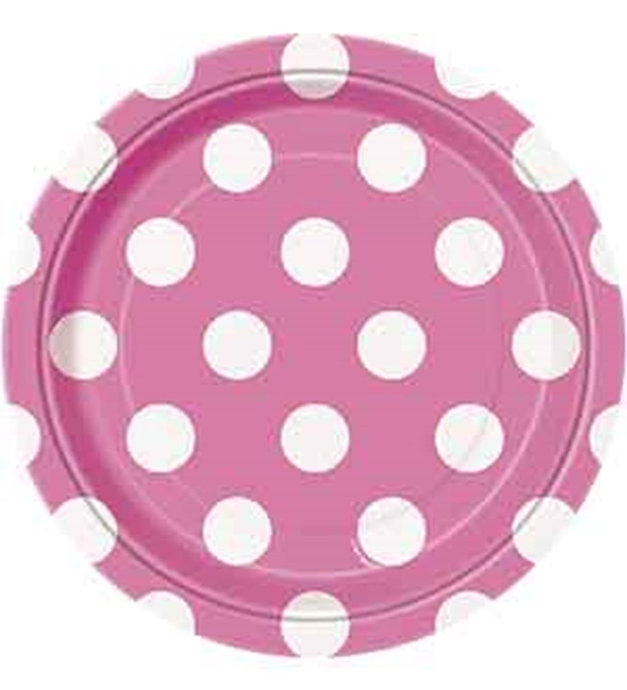 Round hot pink paper plate with large white polka dots and slightly scalloped edges.