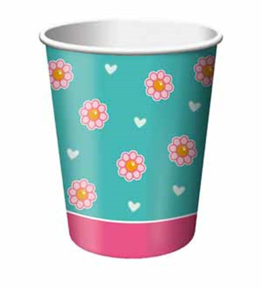 Turquoise paper cup with pink and orange flower pattern and small white hearts, pink base.