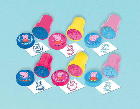 Six Peppa Pig themed stampers in pink, yellow, and blue with matching inked stamps showing Peppa and friends designs.