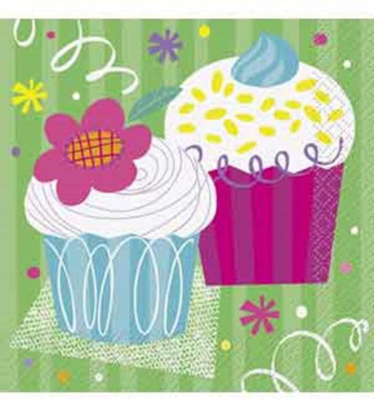 Colorful cupcake-themed napkins with pink and blue cupcakes on a green background with confetti and streamers.