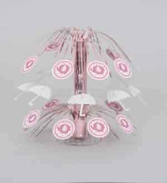Pink metal carousel-themed baby shower centerpiece with hanging umbrella and elephant cutouts.